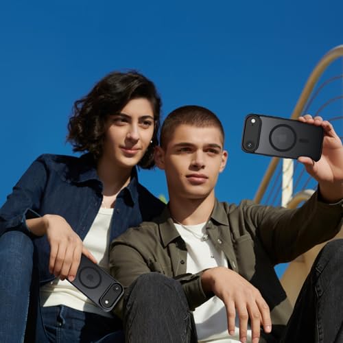 Two people sitting outdoors under a clear blue sky, each holding a black smartphone with a circular MagSafe-style ring design visible on the back.